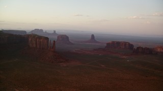 5.5K aerial stock footage of flying by buttes and mesas in famous Monument Valley, Utah, Arizona, sunset Aerial Stock Footage | AX133_179E