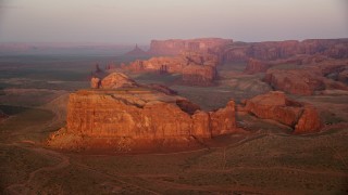 5.5K aerial stock footage of Thunderbird Mesa in Monument Valley, Utah, Arizona, sunset Aerial Stock Footage | AX133_184E