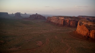 5.5K aerial stock footage of approaching Rain God Mesa near buttes, Monument Valley, Utah, Arizona, sunset Aerial Stock Footage | AX133_187