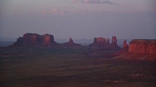 5.5K aerial stock footage of buttes in thick haze, Monument Valley, Utah, Arizona, twilight Aerial Stock Footage | AX133_230E