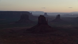 5.5K aerial stock footage of a view of several buttes in Monument Valley, Utah, Arizona, twilight Aerial Stock Footage | AX134_029E