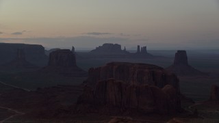 5.5K aerial stock footage wide view of desert buttes in famous Monument Valley, Utah, Arizona, twilight Aerial Stock Footage | AX134_044E