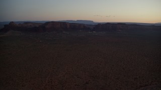 5.5K aerial stock footage video of flying by small town and Oljeto Mesa in Goulding, Utah, twilight Aerial Stock Footage | AX134_071