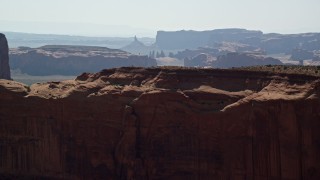 5.5K aerial stock footage fly over Mitchell Mesa, and approach mesas, buttes in Monument Valley, Utah, Arizona Aerial Stock Footage | AX135_012E