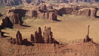 AX135_025 - 5.5K aerial stock footage of flying by Yei Bi Chei Butte and Totem Pole Butte, Monument Valley, Utah, Arizona