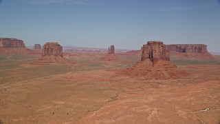 5.5K aerial stock footage of slowly passing buttes in a desert valley, Monument Valley, Utah, Arizona Aerial Stock Footage | AX135_036