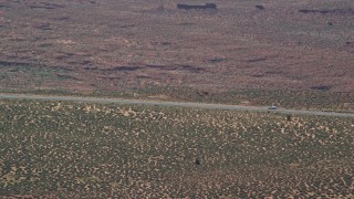 5.5K aerial stock footage of a car slowing to a stop on Highway 163, Monument Valley, Utah, Arizona Aerial Stock Footage | AX135_066E