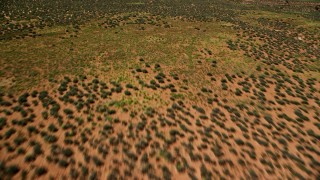 5.5K aerial stock footage of approaching buttes across desert valley, Monument Valley, Utah, Arizona Aerial Stock Footage | AX135_093E