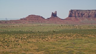 5.5K aerial stock footage of orbiting around grazing horses, giant buttes in the background, Monument Valley, Utah, Arizona Aerial Stock Footage | AX135_099