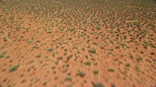 5.5K aerial stock footage tilt from from desert to reveal and fly toward Rooster Rock, Monument Valley, Utah, Arizona Aerial Stock Footage | AX135_134E