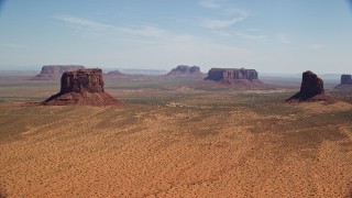 5.5K aerial stock footage of passing by open desert with buttes and mesas, Monument Valley, Arizona, Utah Aerial Stock Footage | AX135_192E