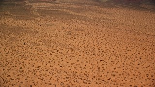 5.5K aerial stock footage tilt from desert, revealing Mitchell Mesa in Monument Valley, Utah, Arizona Aerial Stock Footage | AX136_009E