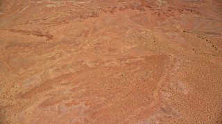 5.5K aerial stock footage tilt from desert valley to reveal East Mitten Butte, Monument Valley, Utah, Arizona Aerial Stock Footage | AX136_030E