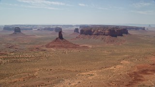 5.5K aerial stock footage of flying away from Big Indian Butte and Sentinel Mesa, Monument Valley, Utah, Arizona Aerial Stock Footage | AX136_042