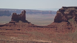 5.5K aerial stock footage of flying away from Setting Hen Butte in Monument Valley, Utah, Arizona Aerial Stock Footage | AX136_045