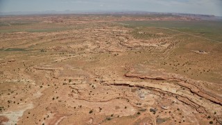 5.5K aerial stock footage of a wide view of open desert valley, north of Monument Valley, Utah, Arizona Aerial Stock Footage | AX136_046E