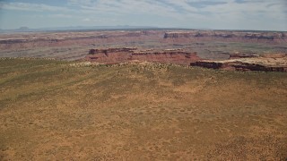 5.5K aerial stock footage of flying over canyon, approaching butte in Navajo Nation Reservation, Utah, Arizona Aerial Stock Footage | AX136_054E