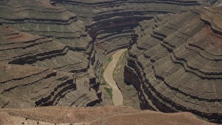 AX136_060 - 5.5K aerial stock footage of lying away from San Juan River in a deep canyon, Navajo Nation Reservation, Utah, Arizona