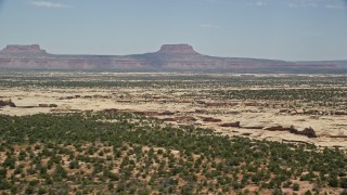 5.5K aerial stock footage of a view of distant mesas across open desert, Cedar Mesa, Utah Aerial Stock Footage | AX136_079