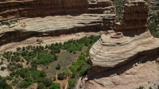 5.5K aerial stock footage of flying low altitude through Grand Gulch, Grand Gulch Primitive Area, Utah Aerial Stock Footage | AX136_101E