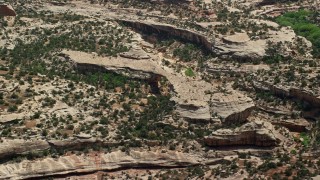 5.5K aerial stock footage of circling Owachomo Bridge, Natural Bridges National Monument, Utah Aerial Stock Footage | AX136_116E