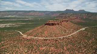 5.5K aerial stock footage of orbiting State Route 275 rounding a butte, Manti-La Sal National Forest, Utah Aerial Stock Footage | AX136_128E