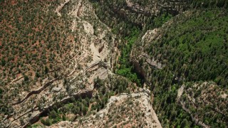 5.5K aerial stock footage of tilt from bird's eye view of Arch Canyon, Utah, then fly away Aerial Stock Footage | AX136_168