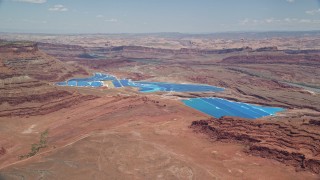 5.5K aerial stock footage of flying toward potash ponds in a desert valley, Moab, Utah Aerial Stock Footage | AX136_268E