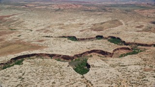 5.5K aerial stock footage of passing by narrow canyons in a desert valley, Moab, Utah Aerial Stock Footage | AX136_286E