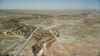 5.5K aerial stock footage of approaching Highway 191 in a desert valley, Moab, Utah Aerial Stock Footage | AX136_293E