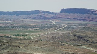 5.5K aerial stock footage of passing by Highway 191 through desert valley, Moab, Utah Aerial Stock Footage | AX137_001E