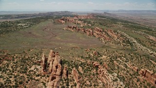 5.5K aerial stock footage fly over rock fins and and desert plants in Eagle Park, Arches National Park, Utah Aerial Stock Footage | AX137_022E