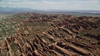 5.5K aerial stock footage of passing by Devil's Garden rock fins at Arches National Park, Utah Aerial Stock Footage | AX137_050