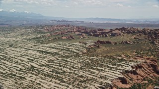 5.5K aerial stock footage of passing rock formations and desert plants in Devil's Garden, Arches National Park, Utah Aerial Stock Footage | AX137_052E