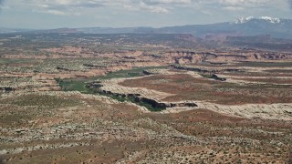 5.5K aerial stock footage of approaching Salt Wash Canyons at Arches National Park, Utah Aerial Stock Footage | AX137_054E