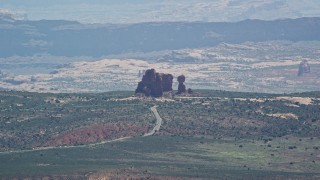 5.5K aerial stock footage of a view of Balanced Rock and Scenic Drive, Arches National Park, Utah Aerial Stock Footage | AX137_059E