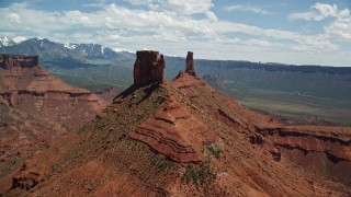 5.5K aerial stock footage flyby a butte to approach Castleton Tower in Moab, Utah Aerial Stock Footage | AX137_135E