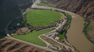 5.5K aerial stock footage tilt to bird's eye view of Red Cliffs Lodge beside the Colorado River in Moab, Utah Aerial Stock Footage | AX138_004E