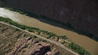 5.5K aerial stock footage of a bird's eye of a desert road by the Colorado River in Moab, Utah Aerial Stock Footage | AX138_007E