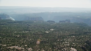 5.5K aerial stock footage of a wide view of Big Bend Canyon in Arches National Park seen from flat desert, Utah Aerial Stock Footage | AX138_019