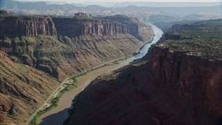 AX138_026E - 5.5K aerial stock footage of a wide view of the Colorado River and road in Big Bend, Arches National Park, Utah