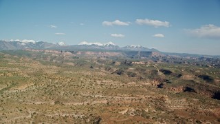 5.5K aerial stock footage of a wide view of a desert landscape, canyon and mesas, Moab, Utah Aerial Stock Footage | AX138_030