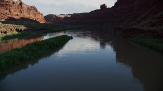 AX138_096E - 5.5K aerial stock footage follow the river through shaded part of Goose Neck, Meander Canyon, Canyonlands National Park, Utah