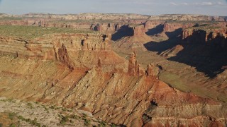 AX138_140E - 5.5K aerial stock footage of Zeus and Moses Butte in Taylor Canyon, Canyonlands National Park, Utah