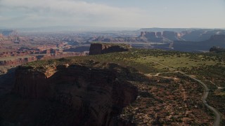 5.5K aerial stock footage approach and tilt to cars parked on Dead Horse Point Overlook with view of Canyonlands National Park, Utah Aerial Stock Footage | AX138_155E