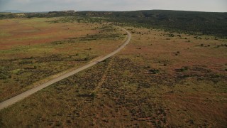 AX138_212E - 5.5K aerial stock footage of Hatch Point Road through open desert in Moab, Utah