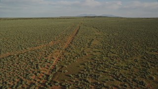 5.5K aerial stock footage fly over open desert and dirt road near Moab, Utah Aerial Stock Footage | AX138_228E