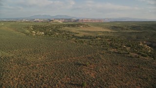 5.5K aerial stock footage of flying over desert, approaching rocky hill, Moab, Utah Aerial Stock Footage | AX138_240E