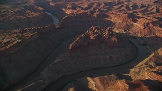 5.5K aerial stock footage orbiting the river in The Loop East part of Meander Canyon, Canyonlands National Park, Utah, sunset Aerial Stock Footage | AX138_304E