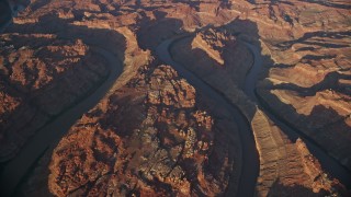 5.5K aerial stock footage of an orbit of the river at sunset, bottom of Meander Canyon, Canyonlands National Park, Utah Aerial Stock Footage | AX138_324E